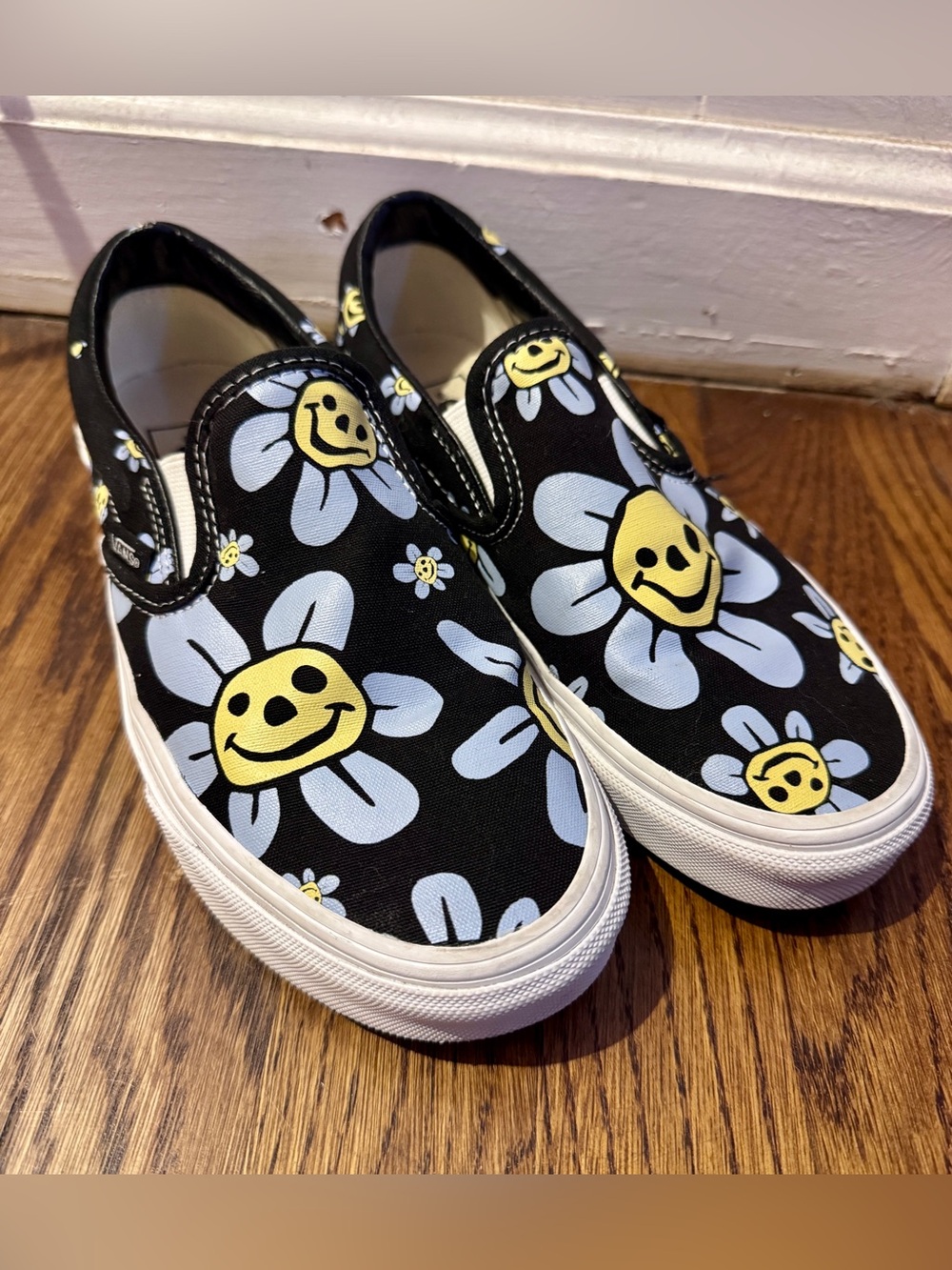 Vans TRIPPY Black Slip-On Sneakers with Yellow Smiley Daisy and Light Blue Petal